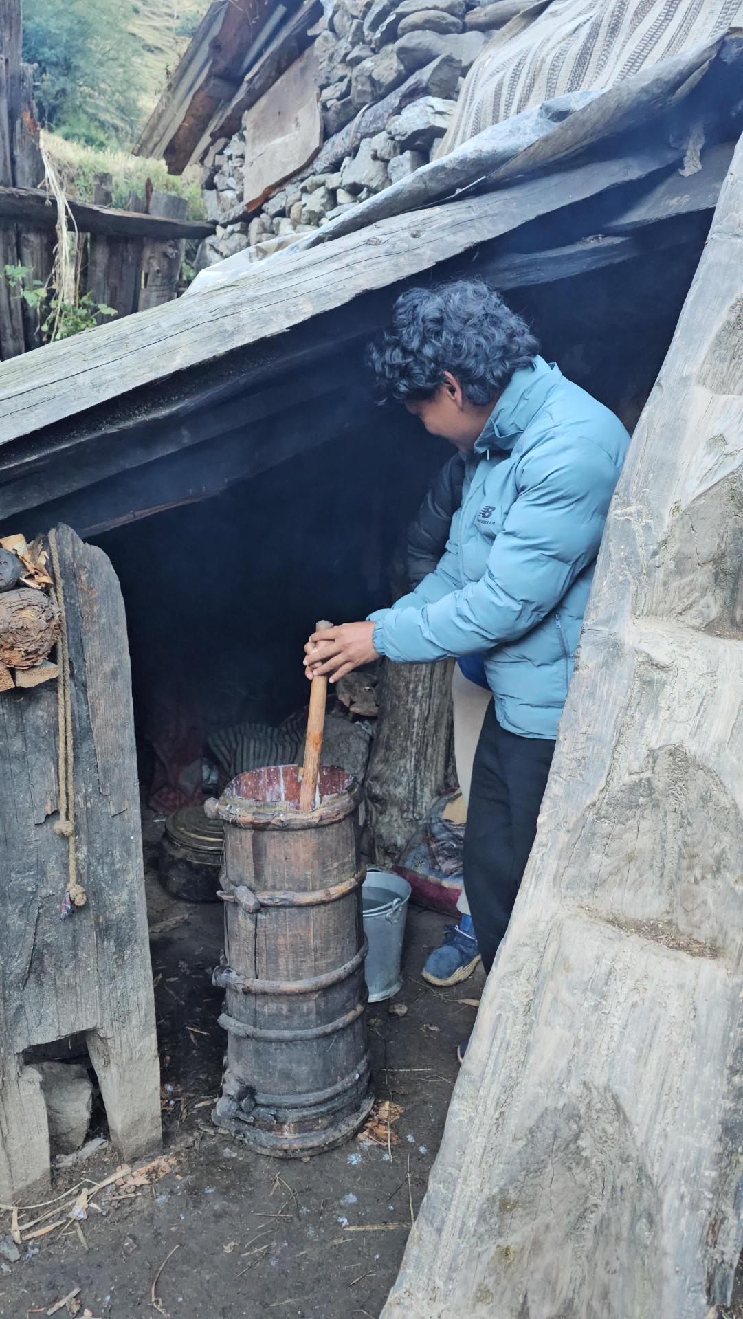 Gagan churning butter the traditional way in a village home