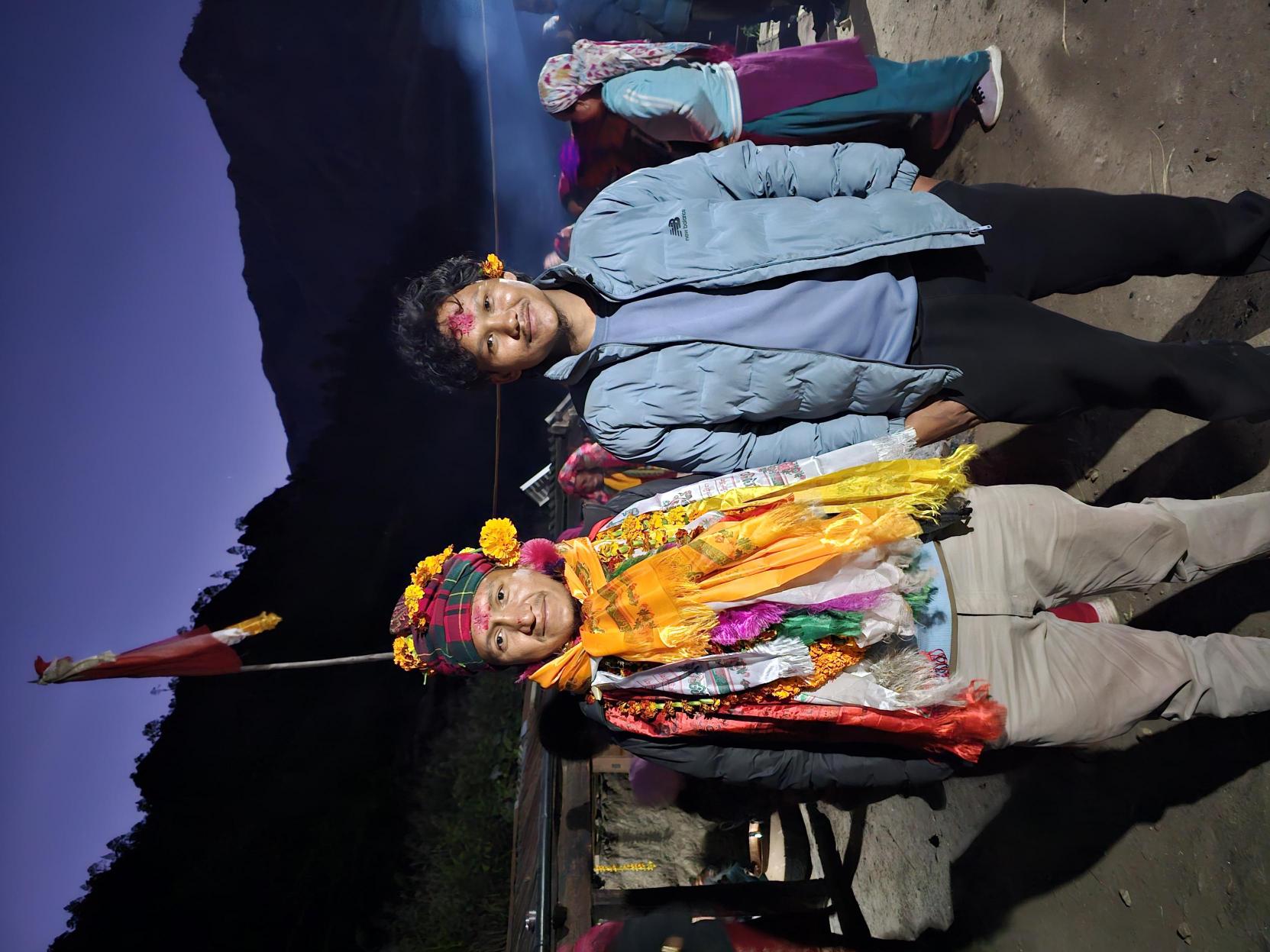 Festival celebration at night with traditional dress and marigold garlands