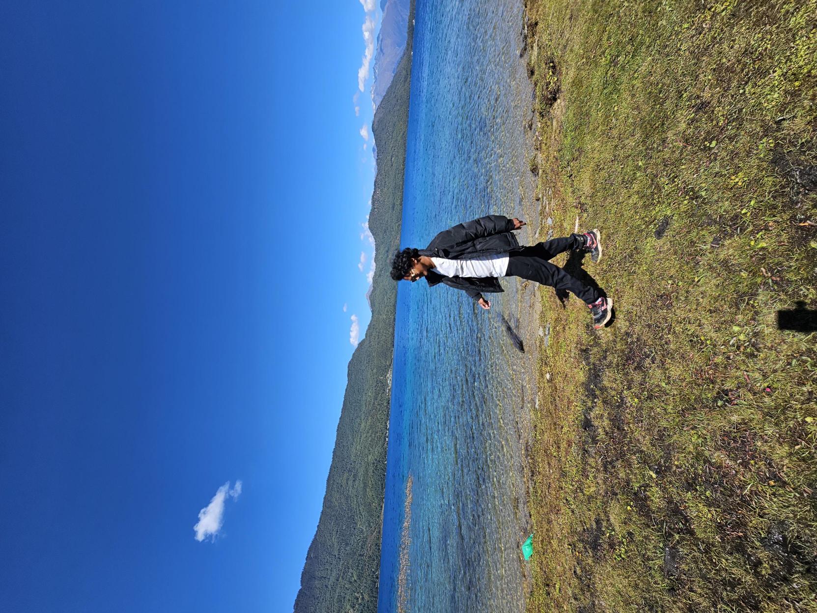 Gagan at Rara Lake with Himalayan peaks behind